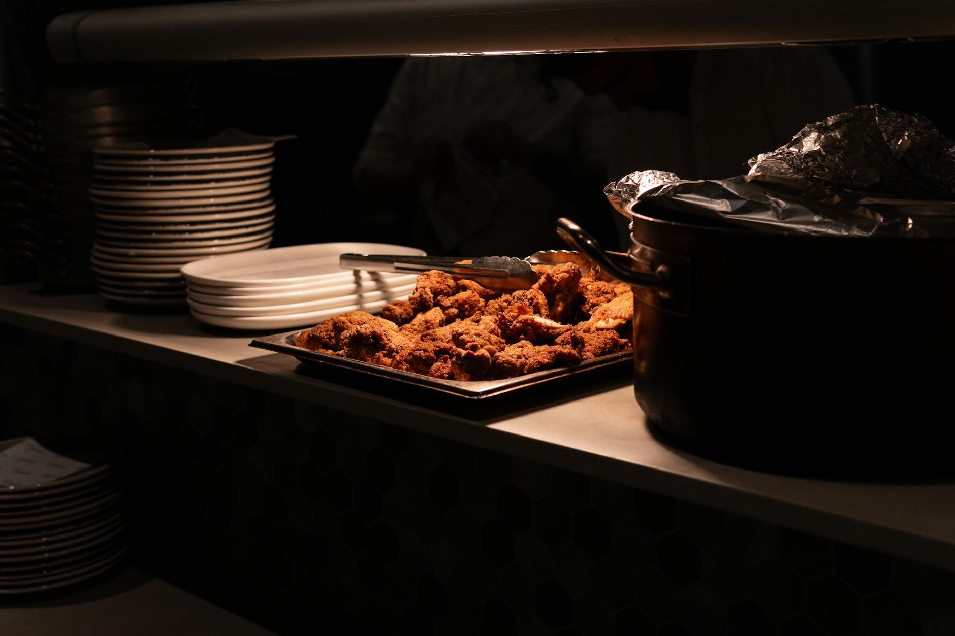 Delicious fried chicken served in restaurant kitchen. Perfect for dining and culinary themes.