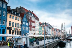 Vibrant buildings and boats line the picturesque Nyhavn waterfront in Copenhagen.