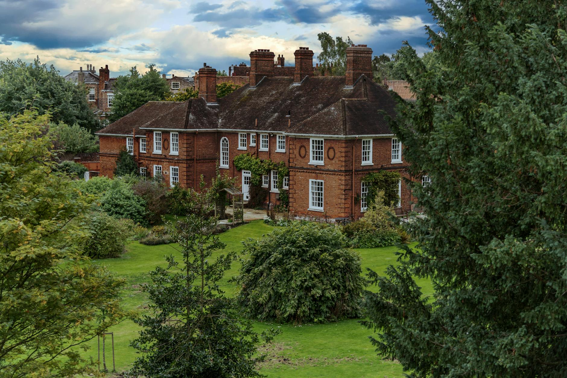 A beautiful brick mansion surrounded by lush greenery in York, England.